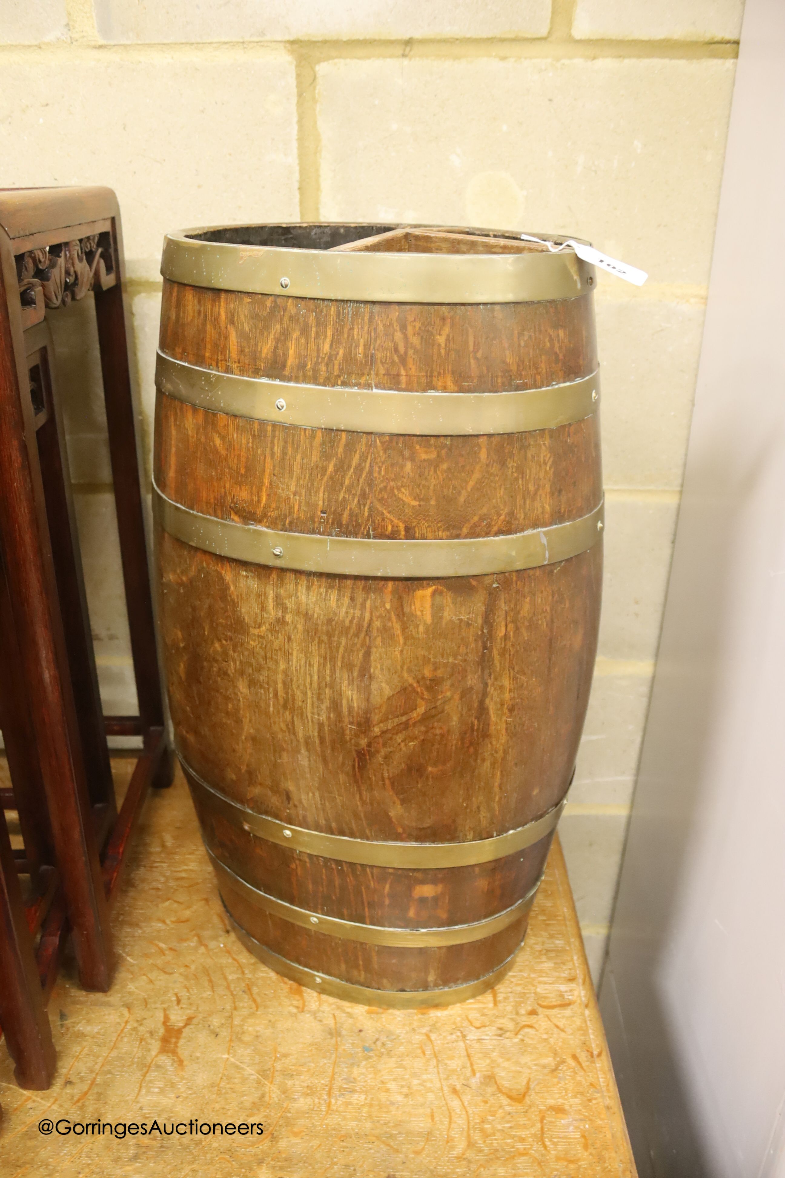 An oval coopered oak barrel stick stand, width 32cm, depth 24cm, height 65cm